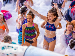Outdoor foam party activity from the Bounce Town 412 rental listing